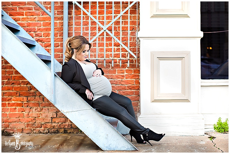 urban maternity portrait on stairs against brick wall