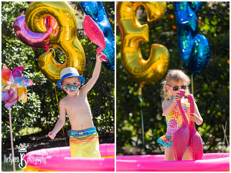twins having fun in pool for third birthday photo session with pink flamingos