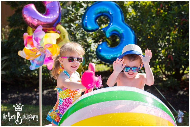 summer fun in Houston for twins third birthday photo session with beach ball