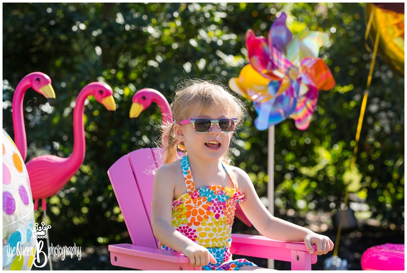 toddler girl at bright rainbow colored pool party