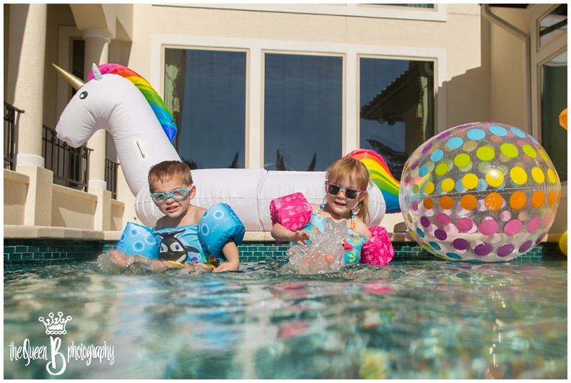 Houston twins in pool with giant unicorn and beach ball