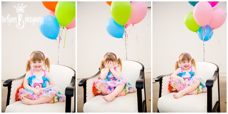 silly pigtails girl at third birthday photo shoot with balloons