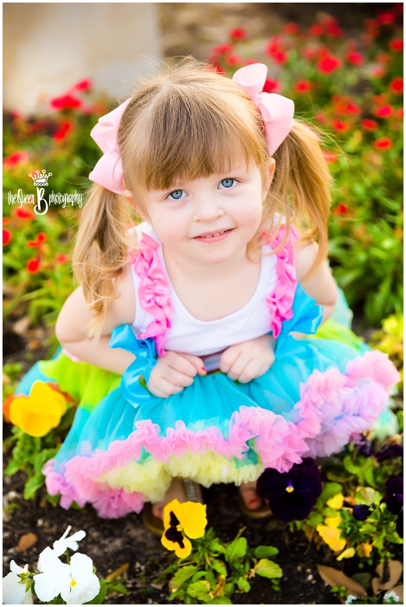 adorable toddler girl with pig tails in flowers