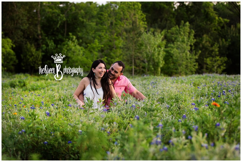laughing couple in field of texas bluebonnet wildflowers
