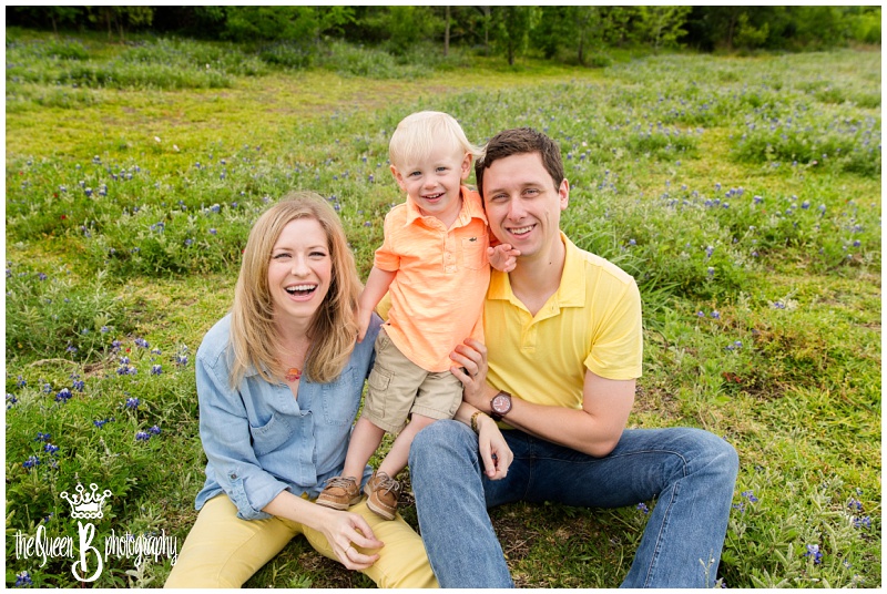 laughing family with toddler boy in field of texas wildflowers