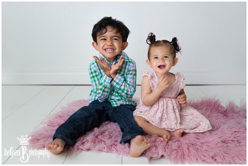 happy laughing siblings in Houston baby photographer The Queen B Photography white studio photo session