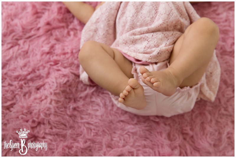 baby girl toes on pink furry rug