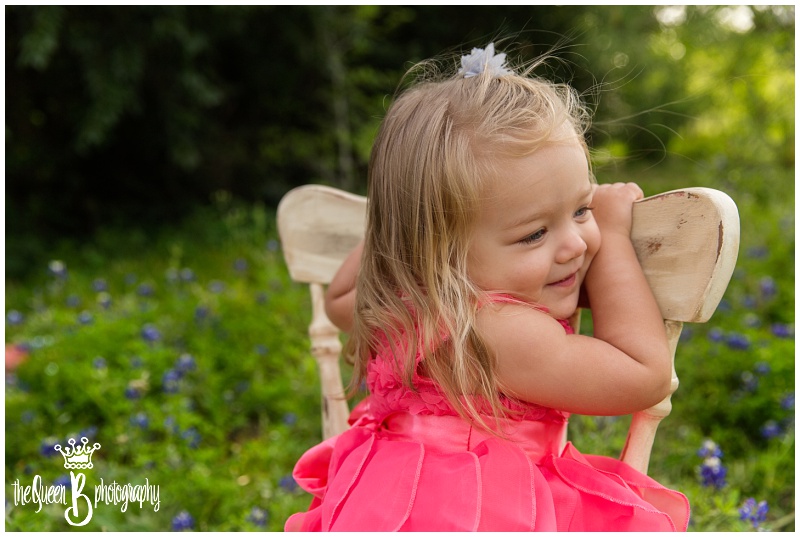 toddler girl on white chair in texas wildflowers