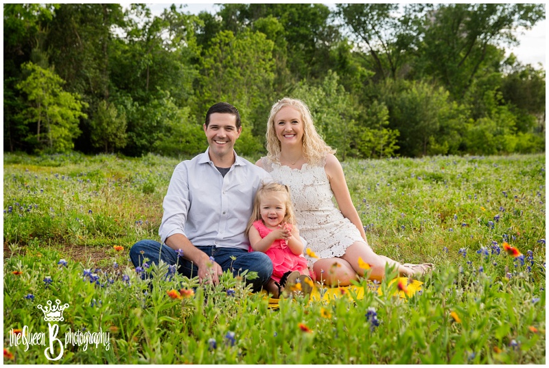 Houston family photographer photo session with toddler girl in bluebonnets and indian paintbrush flowers