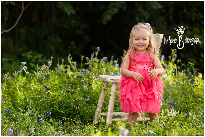 Houston Baby Photographer photo session with toddler girl in field of bluebonnet flowers