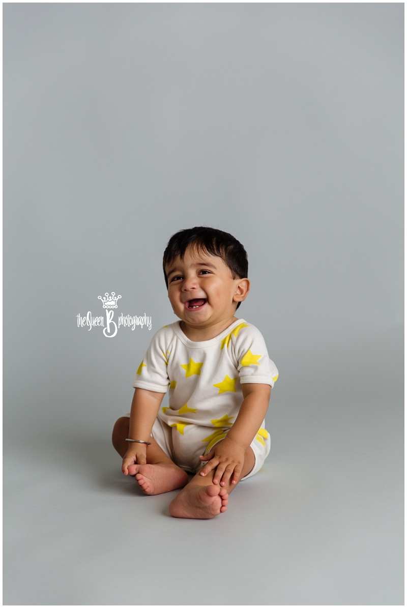 happy baby boy smiling for 1 year portraits