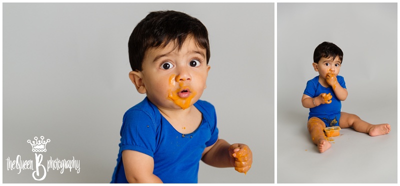 1 year old baby boy making a mess with orange baby food