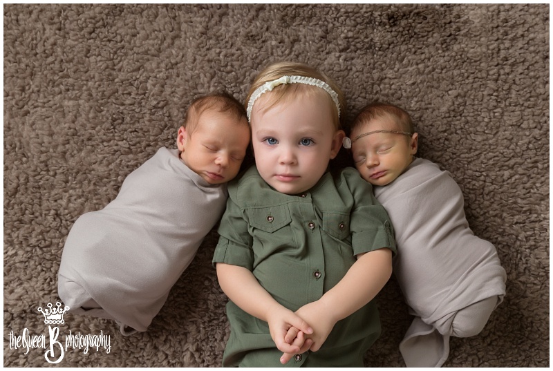 Houston Newborn Photographer captures adorable toddler sister with newborn twin siblings