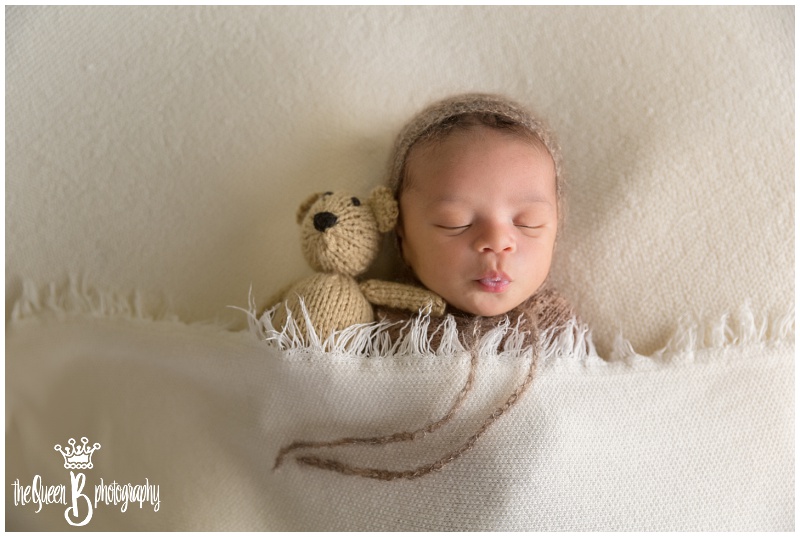 Sugar Land Newborn boy snuggled under blanket with teddy bear
