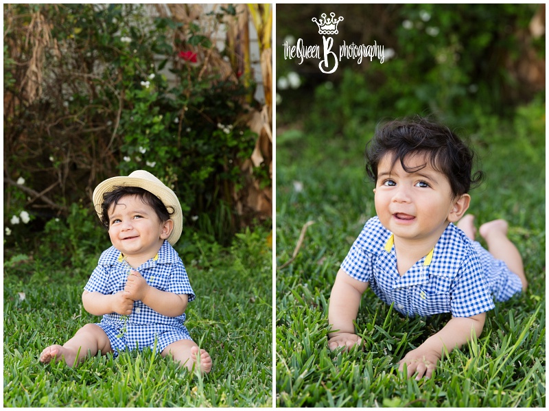 happy baby boy in blue and white check romper on the grass