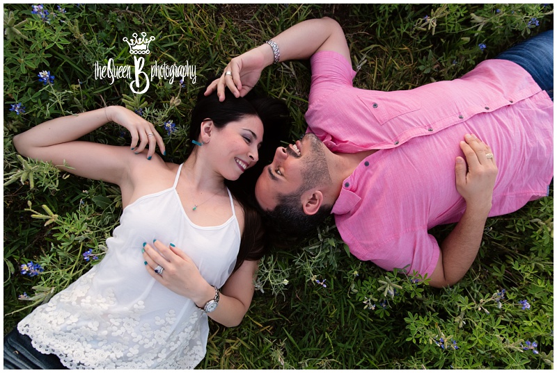 romantic couple lying in texas bluebonnets