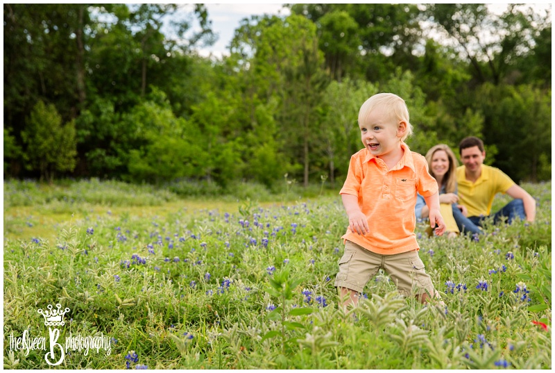 active toddler boy playing in texas wildflowers