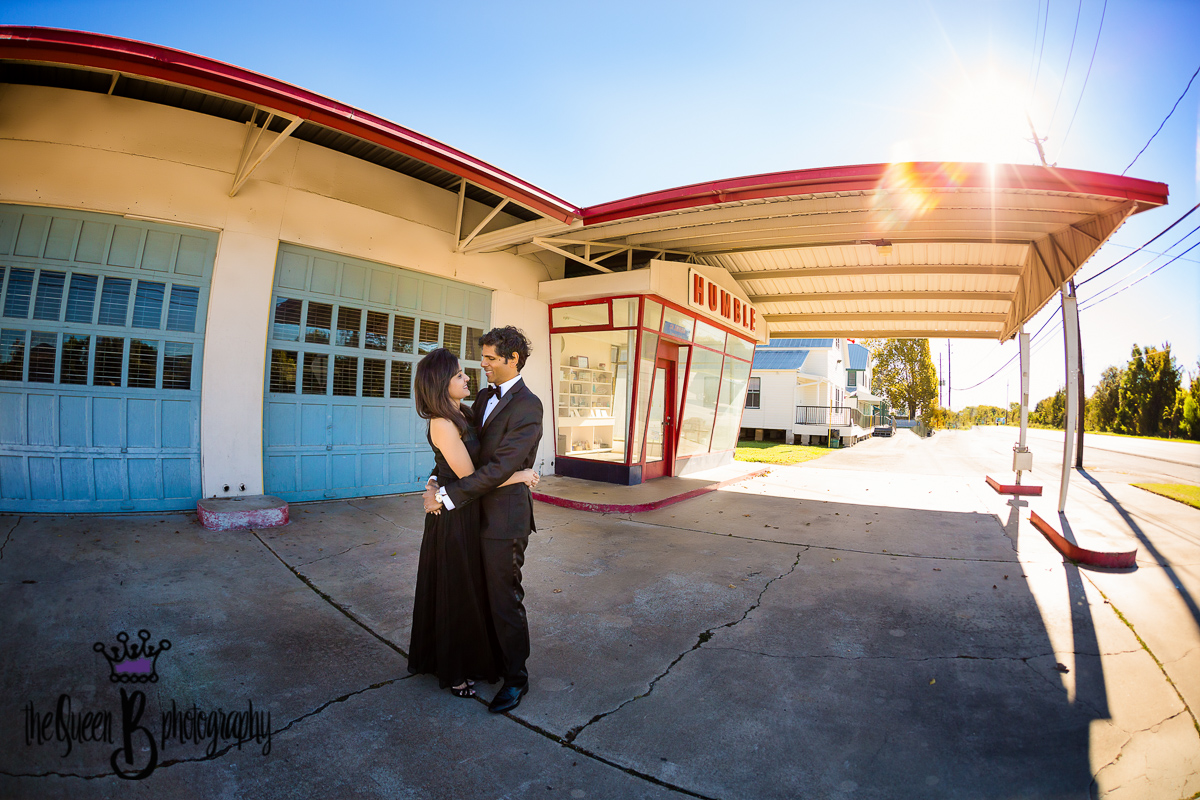 Romantic black tie dressed couple in front of vintage gas station in Cypress Texas