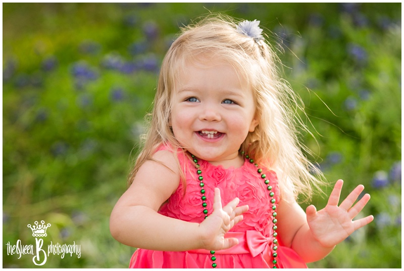 joyful blonde toddler girl in texas bluebonnets