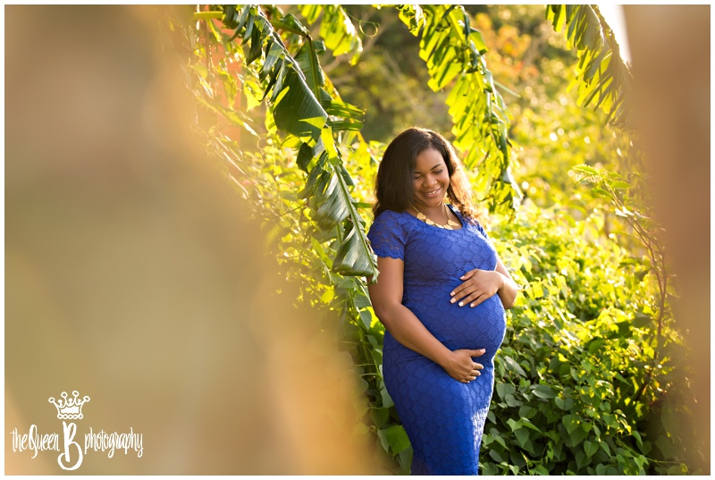 stunning expectant mother in blue maternity dress at sunset